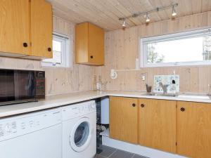 a kitchen with a washing machine and a sink at 8 person holiday home in Højslev-By Traum in Højslev