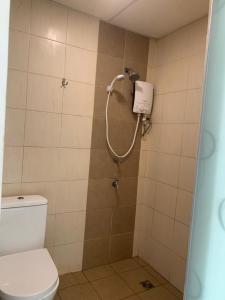 a bathroom with a shower with a toilet at D'Aqiela Homestay @ ITCC in Penampang +20 photos