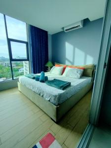 a bedroom with a bed and a large window at D'Aqiela Homestay @ ITCC in Penampang