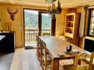 a dining room with a large wooden table and chairs at Chalet Flumet, 6 pièces, 10 personnes - FR-1-505-191 in Flumet