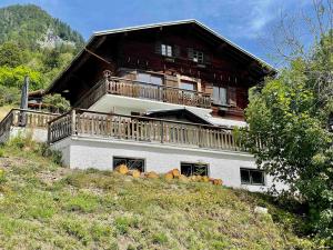 a large house with a balcony on a hill at Chalet Flumet, 6 pièces, 10 personnes - FR-1-505-191 in Flumet