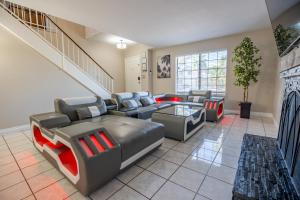 a living room with couches and a staircase at 1800 SqFt House W/Heated Pool Spa 13Min From Strip in Las Vegas