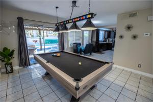 a pool table in the middle of a living room at 1800 SqFt House W/Heated Pool Spa 13Min From Strip in Las Vegas