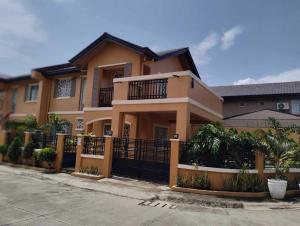 a large house with a fence in front of it at DGM AirBnB Urdaneta Pangasinan 