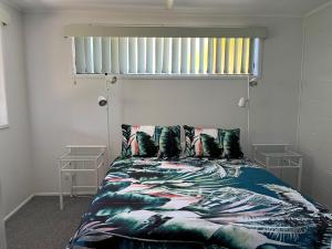 a bedroom with a bed with a colorful blanket at 40 Rumbalara Avenue Rainbow Beach in Rainbow Beach