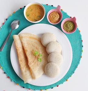 a plate of food with bread and dipping sauce at coorg camping tent stay in Suntikoppa