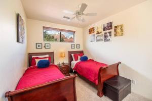 a bedroom with two beds and a ceiling fan at Uptown Sedona Gem: 3-Bed Townhome with Majestic Views and Central Location in Sedona