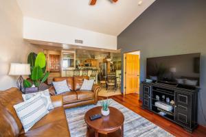 a living room with a couch and a flat screen tv at Uptown Sedona Gem: 3-Bed Townhome with Majestic Views and Central Location in Sedona