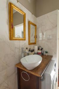 a bathroom with a sink and a mirror at Kurranulla Sapphire - Unit 1 in Cronulla