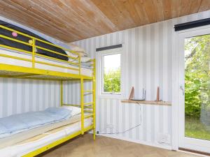 a bedroom with a bunk bed and a window at Holiday home Farsø VIII in Farsø