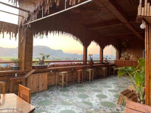 a restaurant with a bar with a view of the ocean at Tam Coc Guest House & Hostel in Ninh Binh