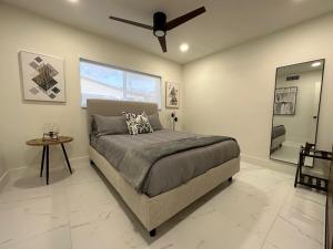 a bedroom with a bed and a ceiling fan at The Sun House - 3 Bed, 2 Bath, Private Pool, Fire Pit, Huge Backyard in Fort Lauderdale