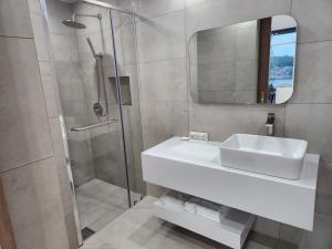 a bathroom with a sink and a shower at Suite Stay Yeosu in Yeosu