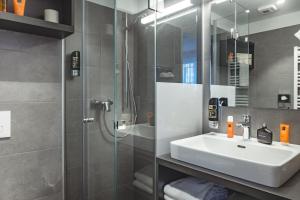 a bathroom with a sink and a shower at Oliver Apartments | contactless check-in in Vienna