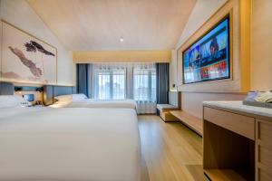 Postel nebo postele na pokoji v ubytování Yiwu Baide Theme Hotel