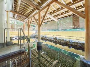 a room with a pool of water in a building at 箱根湯本ホテル in Hakone