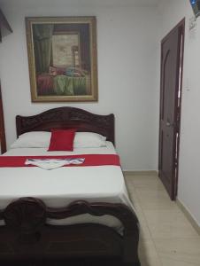 Een bed of bedden in een kamer bij Hostal Kumbaya