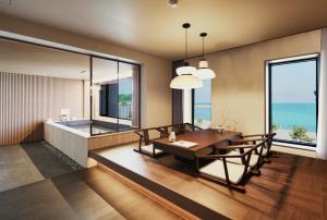 a dining room with a table and chairs and the ocean at Gyeongju Denbasta Ryokan in Gyeongju