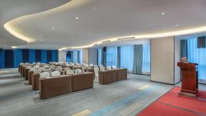 a conference room with rows of chairs and a podium at Holiday Inn Express Changsha Wuyi Plaza , an IHG Hotel in Changsha