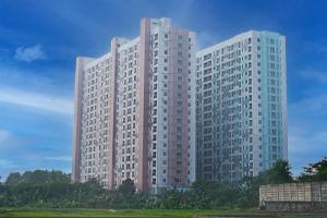 a tall white building with trees in front of it at Collection O 92959 Apartement Sentraland Karawang By AT Room in Karawang
