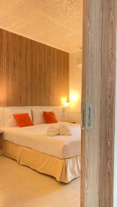a bedroom with a bed with white sheets and orange pillows at Laemsing Natural Beach Resort in Ban Pak Nam +26 photos
