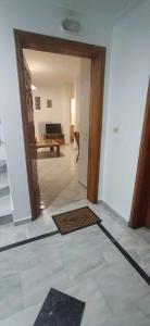 a hallway with a door leading to a living room at Stefano's Home in Potokáki