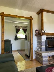 a living room with a fireplace and a couch at Eco Village Highlander in Žabljak