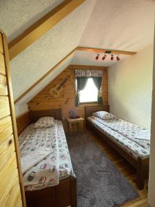a room with two beds and a window at Eco Village Highlander in Žabljak