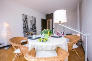 a dining room with a table with a bowl of fruit on it at Lugano Luxury - Happy Rentals in Lugano