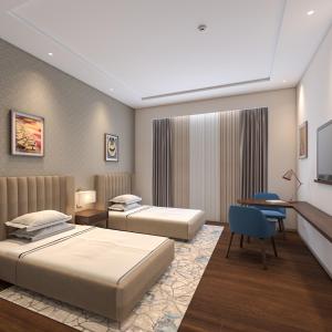 a hotel room with two beds and a desk at Taj Bangalore in Devanahalli-Bangalore