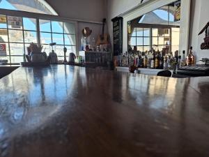 a bar with a wooden counter top in a room at Markos Village Pension in Ios Chora