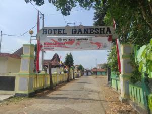 a street with a sign for a hotel at Capital O 93024 Hotel Ganesha in Purworejo