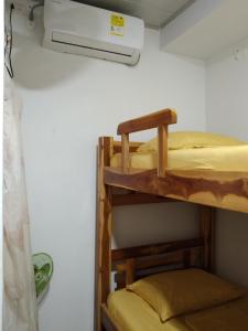 two bunk beds in a room with a air conditioner at Cabañas MaryMar in Necoclí