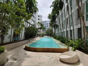 a swimming pool in the middle of a building at 2 Floor - The Base Downtown Condominium next to Central Shopping Mall in Phuket