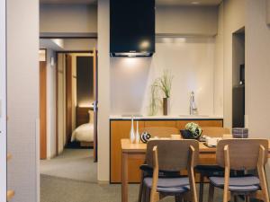 a kitchen and dining room with a table and chairs at MIMARU SUITES Kyoto Shijo in Kyoto