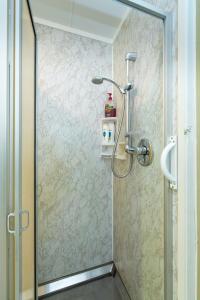 a shower with a glass door in a bathroom at Knights Retreat - Paihia Holiday Home in Paihia +25 photos