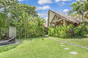 a house in the middle of a garden at Ohana Boutique Villa by Hombali in Canggu