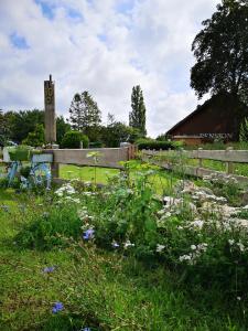 a cemetery with a fence and a clock tower at Pension Trent in Trent