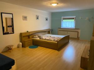 a bedroom with a bed and a wooden floor at Gasthof zur Sägemühle in Hiltpoltstein