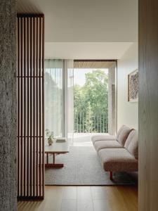 a living room with a couch and a large window at TRUNK(HOTEL) YOYOGI PARK in Tokyo