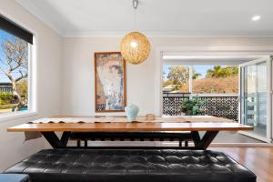 a dining room with a table and a bench at Rosie's in Woody Point