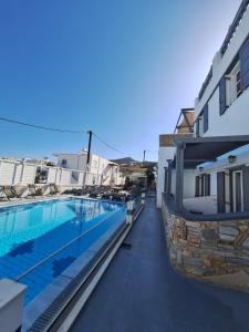 a view of a swimming pool next to a building at Markos Village Pension in Ios Chora
