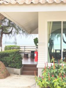 a porch of a house with a view of the ocean at Laemsing Natural Beach Resort in Ban Pak Nam