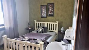 - une petite chambre avec un lit bébé et un lavabo dans l'établissement Ferienwohnung Margit, à Sulzfeld