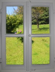 a window with a view of a field of grass at Ferienhaus Masser in Mainsdorf