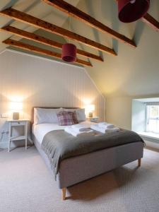 a bedroom with a bed with two lamps on it at Refurbished Highland Lodge in Spectacular Scenery in Pitlochry