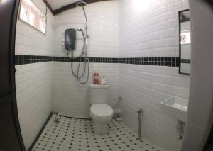 a white bathroom with a toilet and a sink at New Great Shanghai Female Hostel in George Town