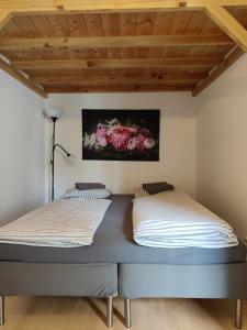 two beds in a room with wooden ceilings at Lovely Apartment near Vienna City Center in Vienna