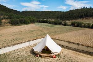 a tent in the middle of a field at Shangri -la Liotard Farm Fix Camp in Shangri-La