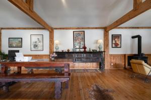 an office with a wooden desk and a fireplace at Shangri -la Liotard Farm Fix Camp in Shangri-La